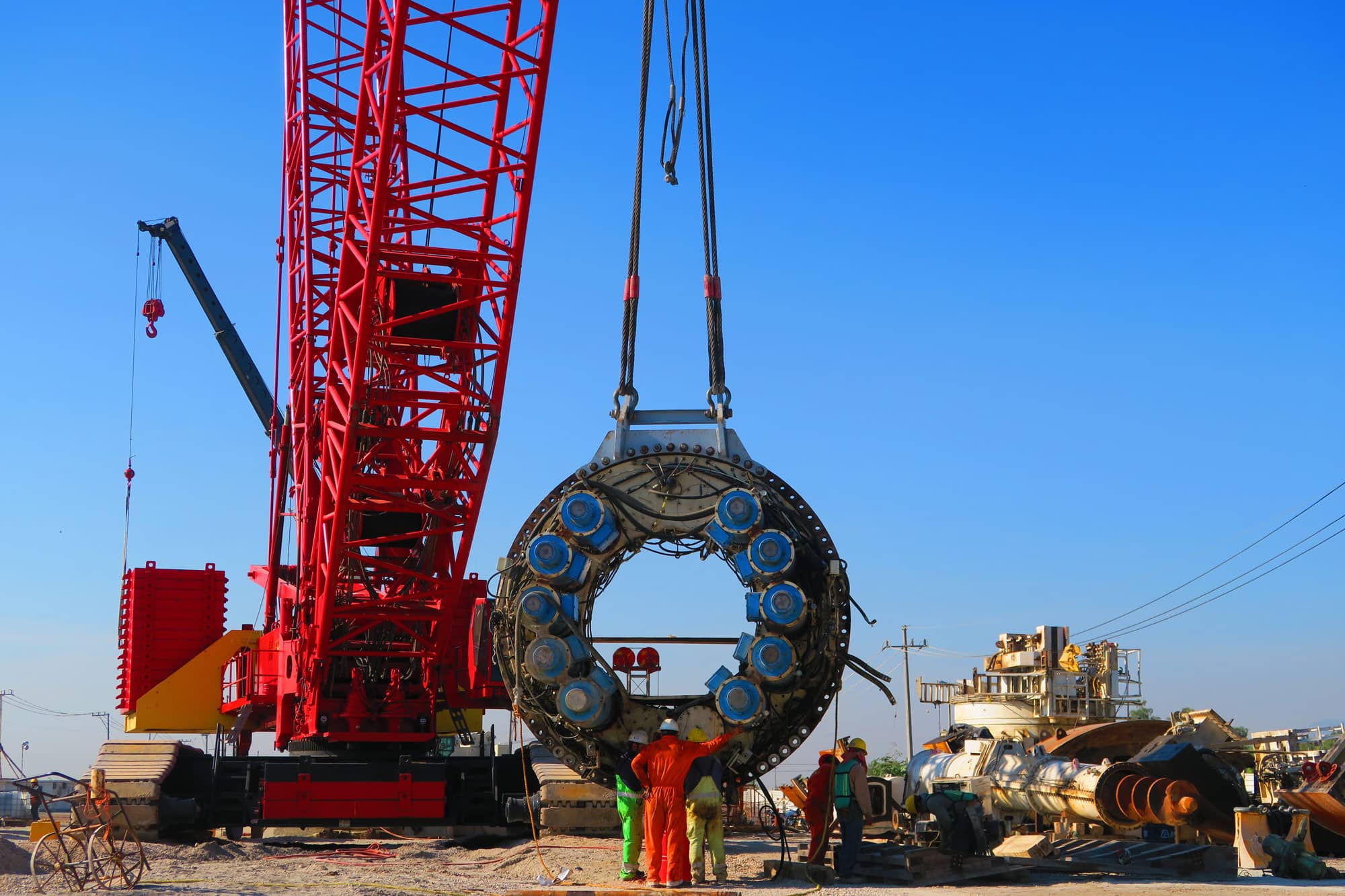 Group of workers setting up crane 